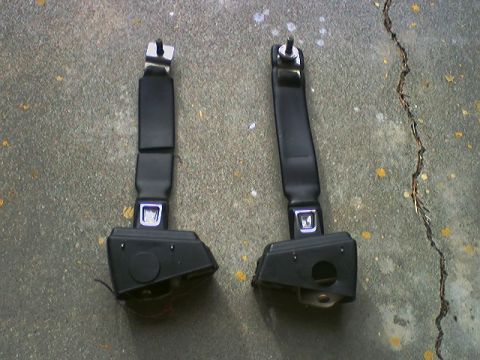1973 Ford Ranchero - Pair of seat belts shown on a concrete surface.