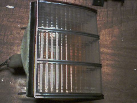 1973 Ford Ranchero - This clear tail light assembly features a fluted lens design and is shown from the side.