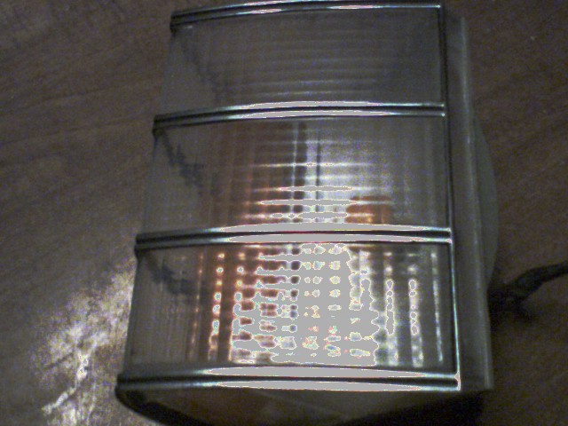 close-up of a clear plastic tail light assembly with chrome trim