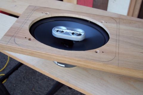1990 Ford Bronco - A wooden panel is prepared to mount a speaker, showing cutouts and screw holes.
