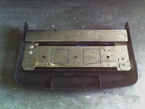1993 Ford C-350 (Centurion Conversions) - A close-up view of a vehicle's dashboard component, showing a metal plate with wiring and mounting holes.