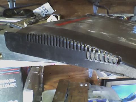 1993 Ford C-350 (Centurion Conversions) - A close-up view of a dark-colored vehicle panel with a series of vertical slots.