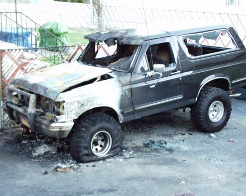1989 Ford Bronco - This 1989 Ford Bronco appears to have been burned to the ground, with significant damage to the front end and windshield.