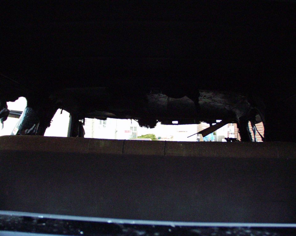 Interior view of a heavily damaged vehicle, possibly burned