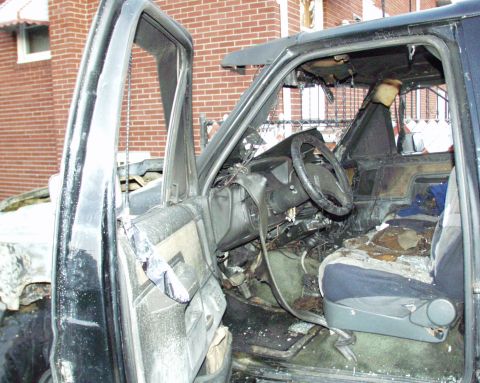 1989 Ford Bronco - The interior of a heavily damaged SUV shows extensive fire damage, with melted plastics and charred upholstery.