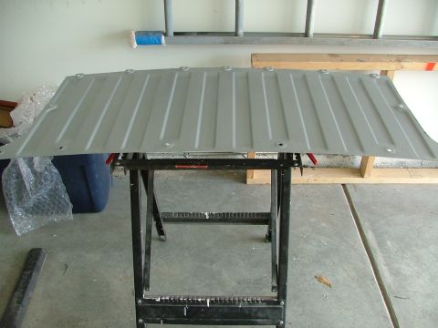 1969 Ford Ranchero - A metal car tailgate is supported by a sawhorse in a garage setting.