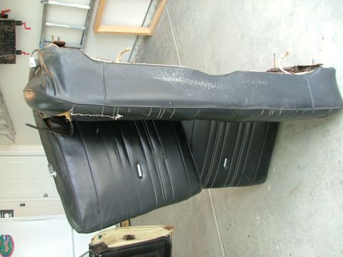 1969 Ford Ranchero - Disassembled black vinyl car seats with chrome accents are laid out on a concrete floor.