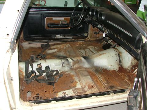 1969 Ford Ranchero - Interior view of a 1969 Ford Ranchero, highlighting extensive rust on the floor pans.