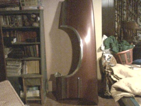 1973 Ford Ranchero - A car fender with chrome trim is shown indoors, leaning against a wall next to a bookshelf.