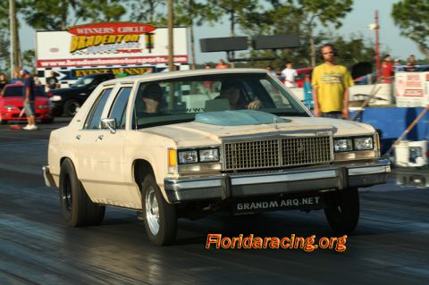 1985 Ford Crown Victoria LTD - Modified 1985 Ford Crown Victoria LTD drag racing on a sunny day.