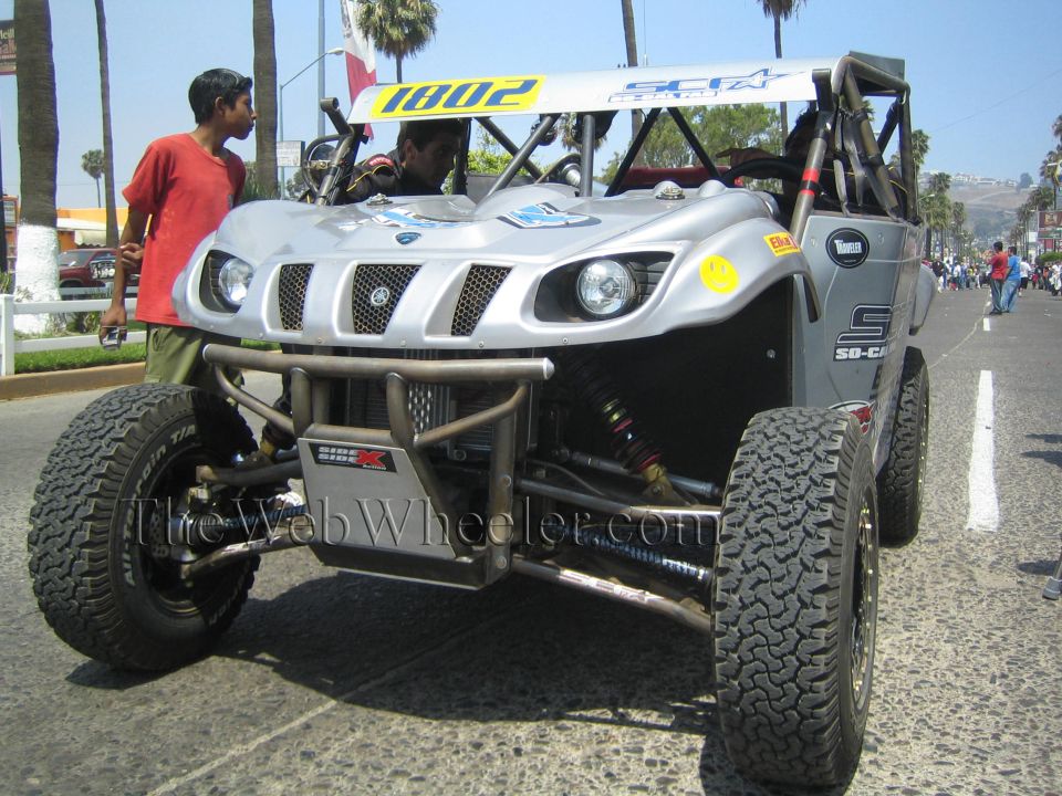 Silver tube-frame off-road buggy 1802 with winch on a cobblestone street