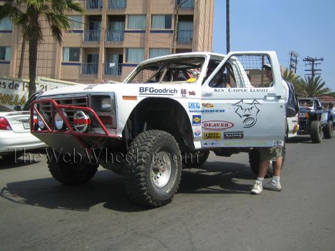 1990 Ford Bronco - White off-road Ford truck with a red front bumper, BFGoodrich and Deaver decals and 'Ken Casper Leavitt' lettering staged on a street.
