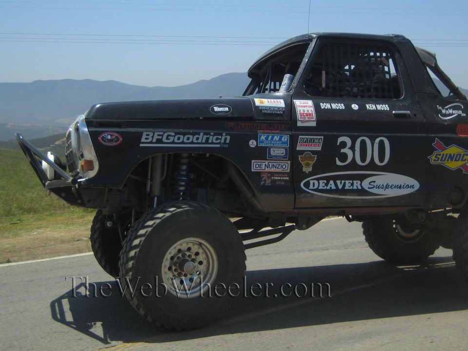 Front of a lifted black number 300 race truck with BFGoodrich and Deaver decals