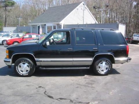 1998 Chevrolet Tahoe - Side view of a black 1998 Chevrolet Tahoe with silver trim.