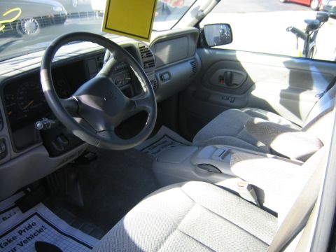 1998 Chevrolet Tahoe - The interior of a Chevrolet or GMC pickup truck or SUV from the mid-1990s is visible, including the dashboard and seats.