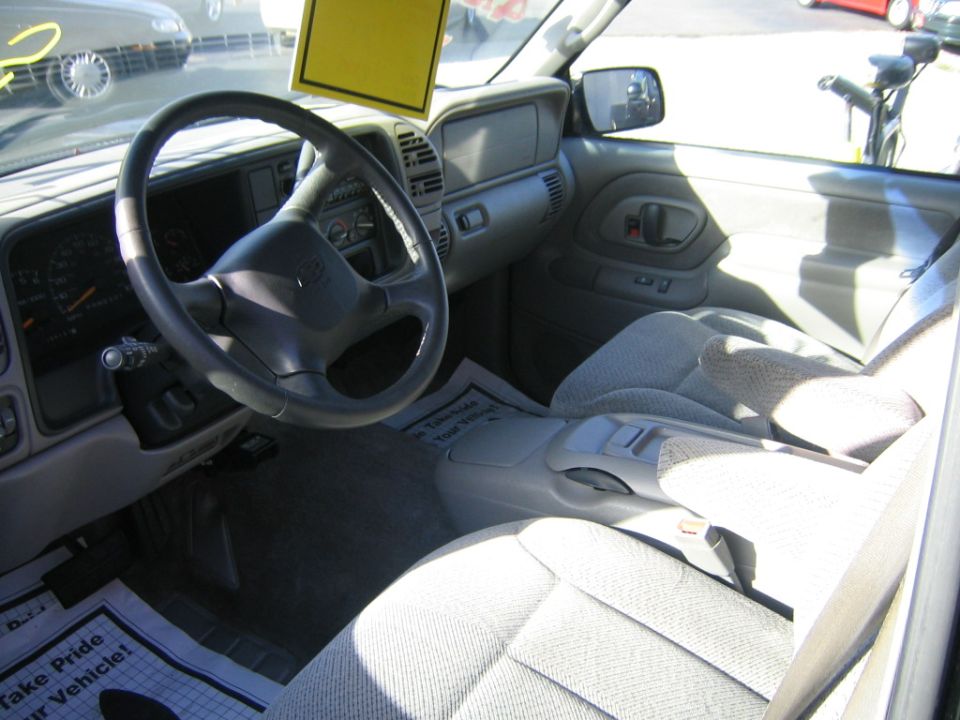 Interior of a 1995 Chevrolet/GMC pickup truck or SUV, showing the dashboard, steering wheel, and seats