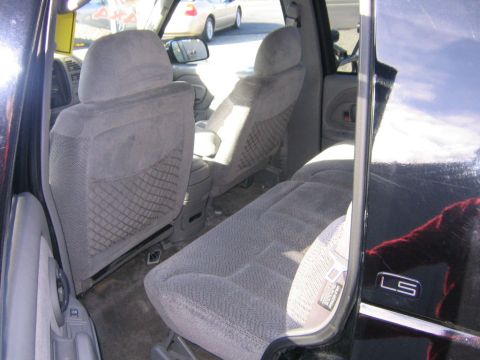 1998 Chevrolet Tahoe - Interior view of a black SUV, showing the rear seats and an 'LS' badge on the door.