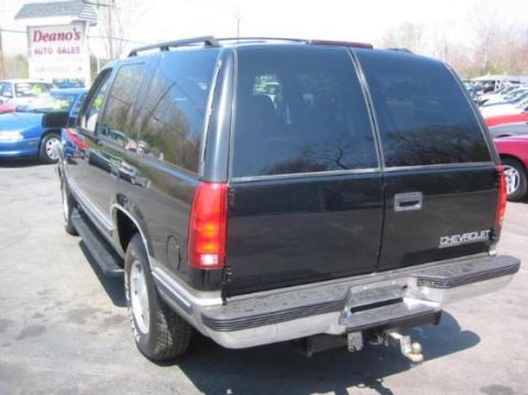1998 Chevrolet Tahoe - Rear view of a black 1998 Chevrolet Tahoe parked at a dealership.