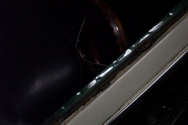 1968 Ford Mustang interior showing a dark seat, steering wheel, and a green and white trim piece