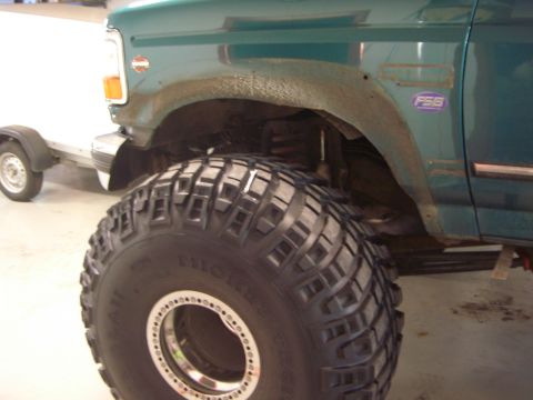 1996 Ford Bronco - This 1996 Ford Bronco is equipped with large off-road tires and is shown with a trailer in the background.