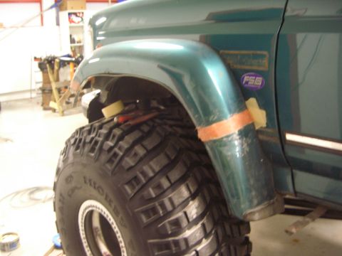 1996 Ford Bronco - Close-up of a green SUV's fender and tire, showing modifications and a 'FSB' badge.