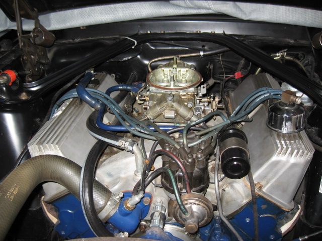 1968 Shelby GT500 engine bay with a Holley carburetor, aluminum valve covers, and blue spark plug wires