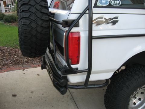 1996 Ford Bronco - This SUV features a rear-mounted spare tire and 4x4 badging, suggesting a model year earlier than claimed.