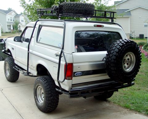 1996 Ford Bronco - This 1996 Ford Bronco features a roof rack and a spare tire mounted on the rear.