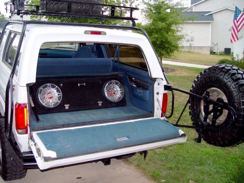 1996 Ford Bronco - Rear view of a white Ford Bronco with aftermarket speakers installed in the cargo area.