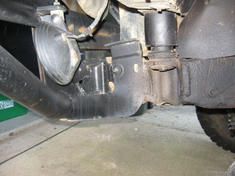 1996 Ford Bronco - Undercarriage view of a vehicle, focusing on the frame and suspension system components.