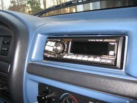 1996 Ford Bronco - Close-up of an aftermarket Alpine CD receiver installed in a vehicle's dashboard.