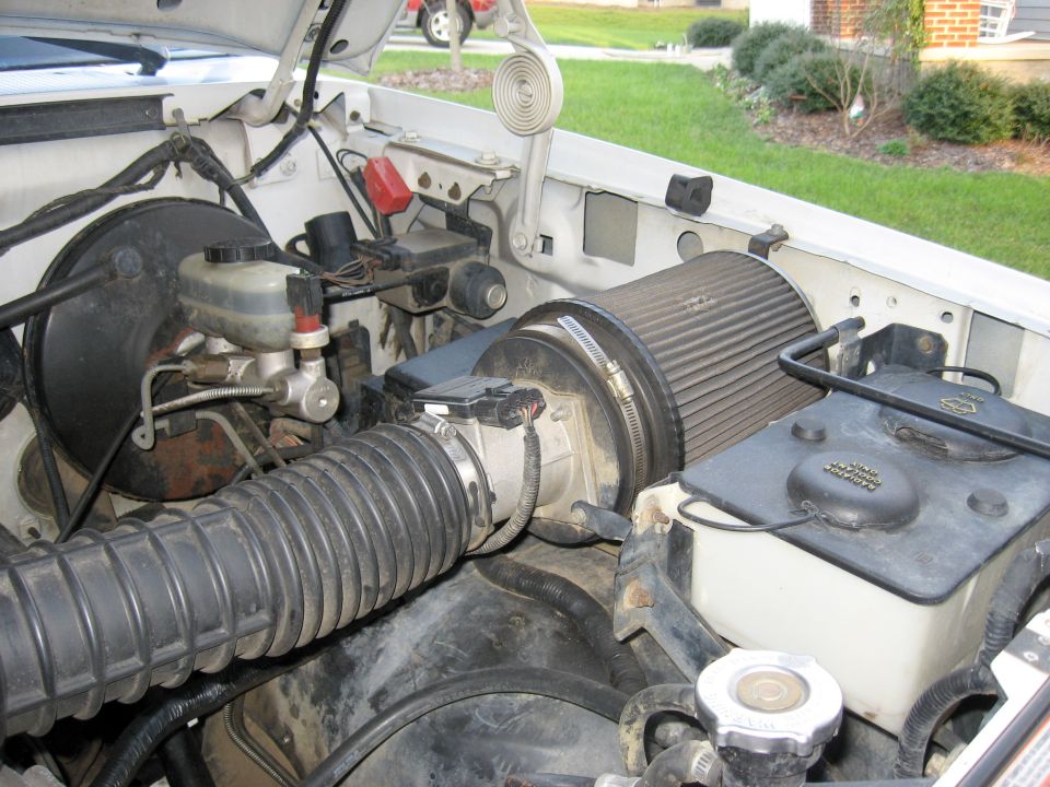 1996 Ford Bronco engine bay showing brake booster, master cylinder, and aftermarket air intake system