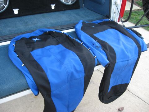 1996 Ford Bronco - Two jackets are placed in the open tailgate of a white truck, with speakers visible in the background.