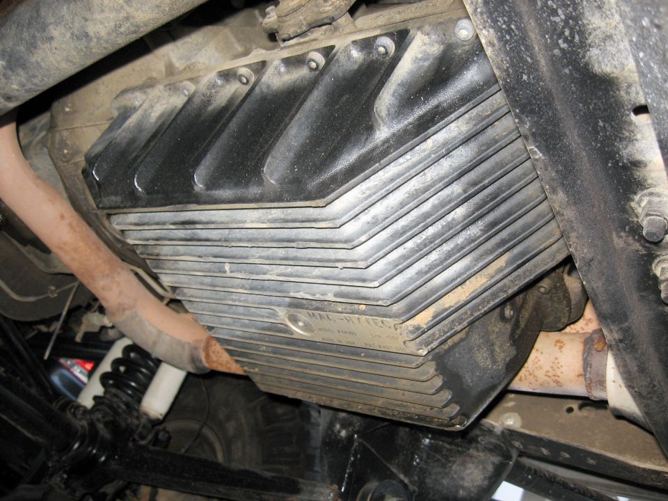 Finned cast-aluminum deep transmission pan installed under a truck