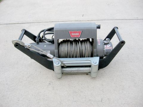 1996 Ford Bronco - A Warn XD9000i winch, a vehicle recovery tool, is shown mounted on a bracket.