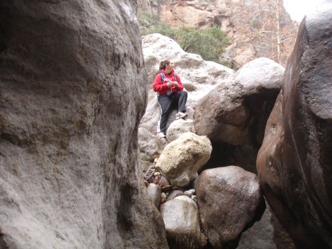 1984 Ford Bronco - A person stands amidst large boulders in a rocky canyon.