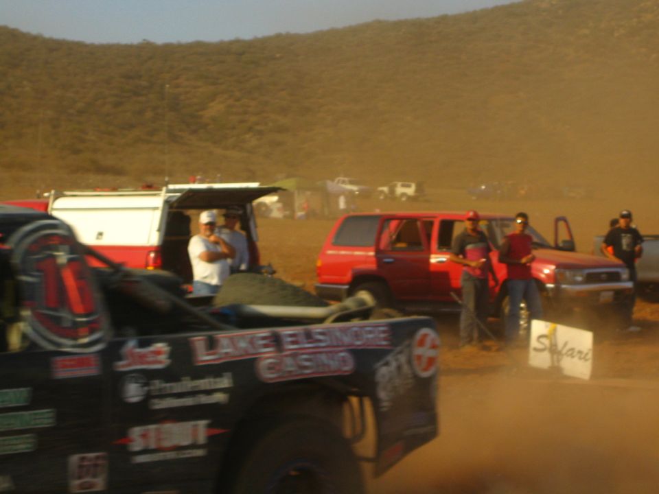 Black race truck cab with Lake Elsinore Casino livery in dusty pits