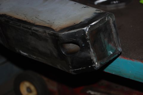 1996 Ford Bronco - Close-up view of a custom-fabricated rear bumper section, showing welding details and a hole for a light or sensor.