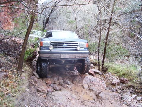 1991 Ford Bronco - This lifted Ford truck navigates a rocky, off-road path in a canyon.