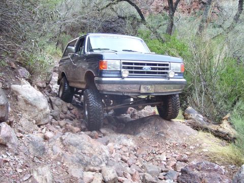 1991 Ford Bronco - This 1991 Ford Bronco is shown tackling a challenging, rocky off-road path.