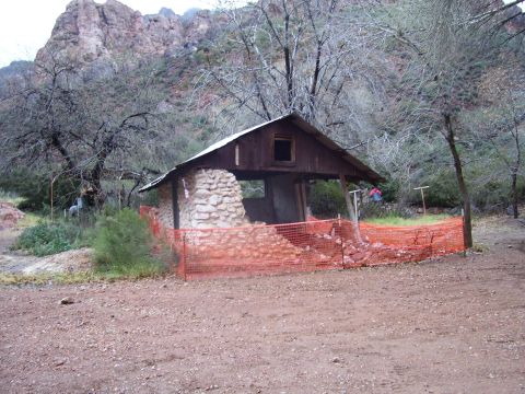 1991 Ford Bronco - An old, partially collapsed structure stands in a remote, mountainous area, cordoned off with orange construction netting.