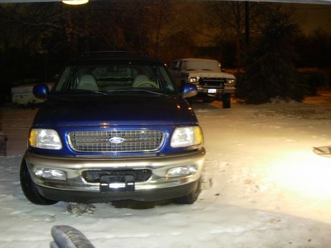 1997 Ford Expedition - A blue 1997 Ford Expedition sits in the snow, with another vehicle behind it.
