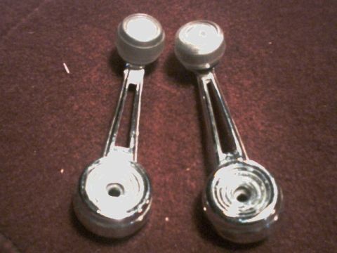1973 Ford Ranchero - Pair of chrome window crank handles with black knobs, likely for an older vehicle interior.