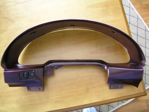 1993 Ford Probe - This is a close-up of a car's dashboard trim piece, showing a single black switch on the left side.