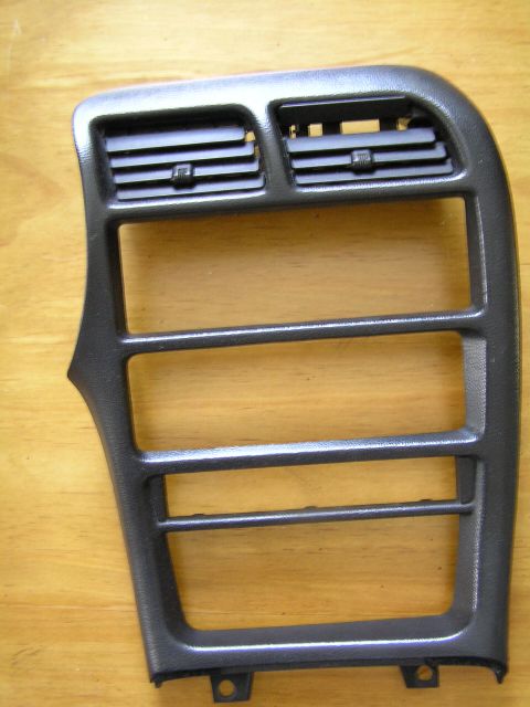 1993 Ford Probe - This dark gray center console air vent trim features horizontal slats and is a replacement part.