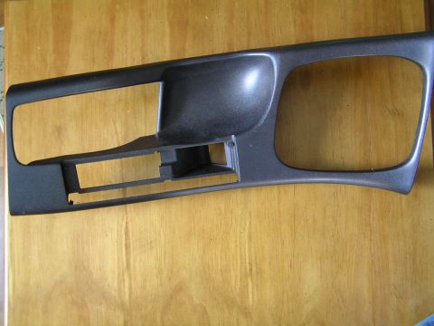 1993 Ford Probe - This gray plastic dashboard trim piece has two large openings and a smaller rectangular cutout for controls.