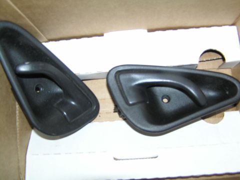 1993 Ford Probe - Pair of black interior door handles, likely for a car, shown in a box.