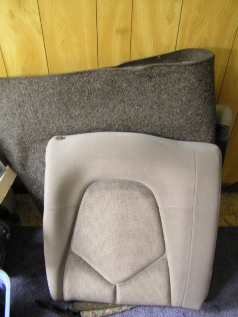 1993 Ford Probe - A car seat and a large roll of carpet are shown indoors, with a Supermotors.net logo at the bottom right.