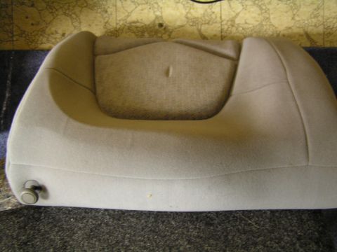 1993 Ford Probe - This tan car seat cushion features a small knob on its side and appears to be from a vehicle's interior.