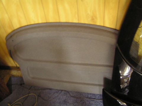 1993 Ford Probe - Interior panel from a car's trunk area, showing textured plastic and yellow fabric lining.